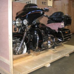 Motorbike being crated at warehouse