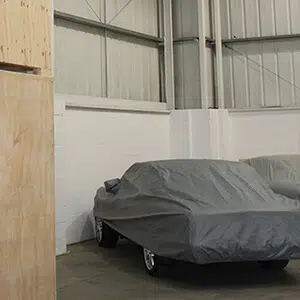 Car with covering in storage warehouse