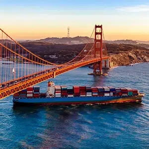 Container ship passing under San Francisco bridge